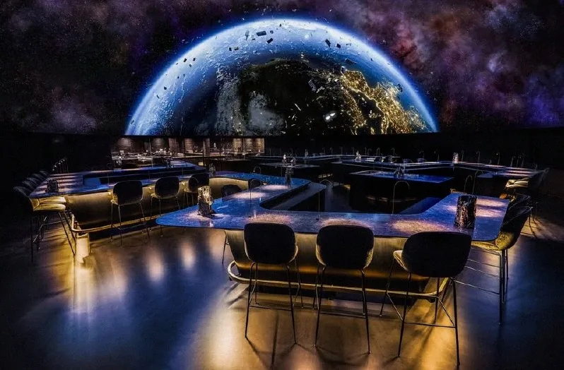 The 360° dome at Alchemist projecting Earth from orbit over the dining tables
